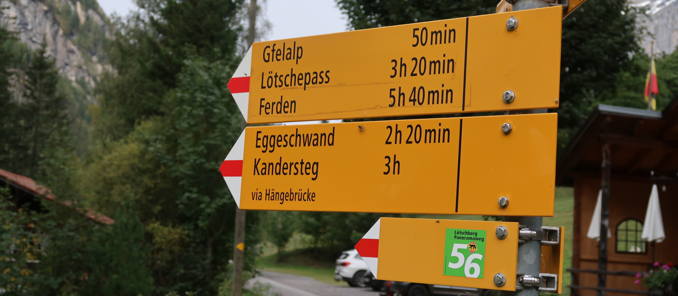 Yellow hiking signpost with five destinations, one of which is Lötschenpass 3h 20min